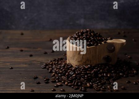 Kaffeebohnen in einer Holztasse Stockfoto