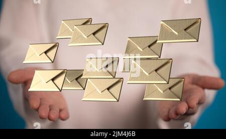 Ein Geschäftsmann bietet viele E-Mail-Symbole Konzept in einer Hand mit verschwommenem männlichen Hintergrund Stockfoto