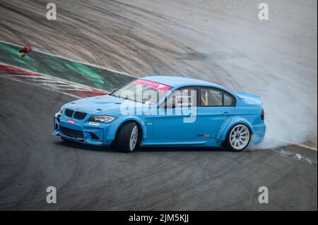 BMW 3 Series E90 driftet auf der Rennstrecke Stockfoto