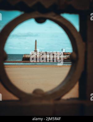 Großes Schiff in einem Hafen von einem Bullauge aus gesehen Stockfoto