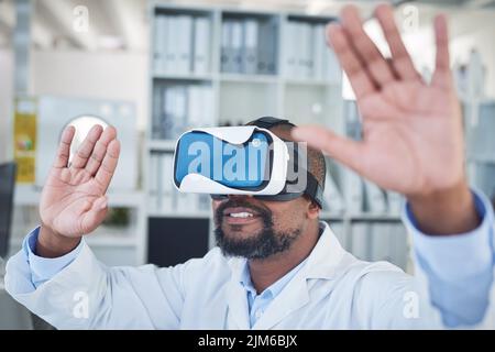 Je mehr wir uns entwickeln, desto mehr lösen wir. Ein Wissenschaftler, der ein Virtual-Reality-Headset verwendet, während er in einem Labor forscht. Stockfoto