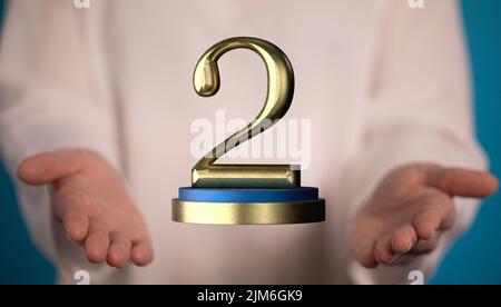 Eine 3D-Darstellung eines zweiten Platzes mit goldenem Award und einer männlichen Hand, die auf einem verschwommenen Hintergrund gehalten wird Stockfoto