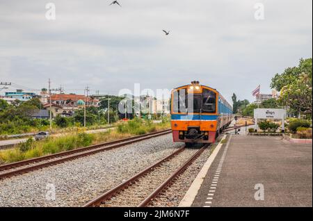 Ein Zug fährt in einen Bahnhof und wartet in Thailand auf Fahrgäste Stockfoto