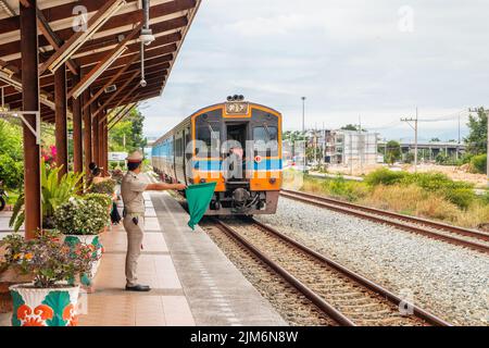 Ein Zug fährt in einen Bahnhof und wartet in Thailand auf Fahrgäste Stockfoto