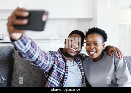 Chillen mit meiner Nummer eins heute. Ein junges Paar, das zu Hause Selfies macht. Stockfoto