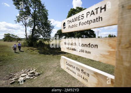 Die Menschen gehen in der Nähe der traditionellen Quelle der Themse, bekannt als Thames Head, einer Gruppe von saisonalen Quellen in der Nähe des Dorfes Coates in den Cotswolds, Gloucestershire. Ausgetrocknete Teile Englands stehen unter sehr trockenen Bedingungen und vor einer weiteren vorhergesagten Hitzewelle vor einem Schlauchleitungsverbot. Bilddatum: Freitag, 5. August 2022. Stockfoto