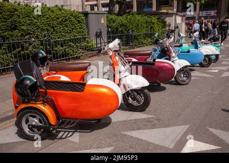 E-Vespina Roller mit Seitenwagen können für Stadtrundfahrten in der Nähe des Kölner Doms gemietet werden. E-Vespina Roller mit Seitenwagen stehen z Stockfoto