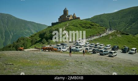 Stepantsminda, Georgia, zeigt Gergeti Trinity Church , Tsminda Sameba oder Holy Trinity Church, in der Nähe des Dorfes Gergeti Außenansicht bei Tageslicht. Stockfoto