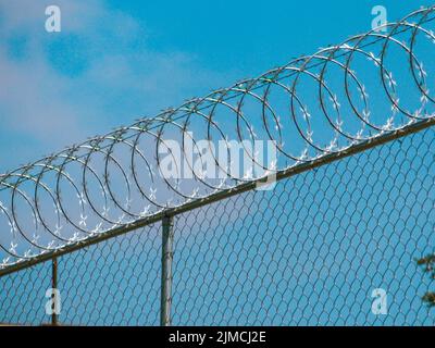 Sicherheitszaun über einem Standard hohen Zaun Stockfoto