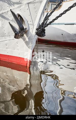 Nasaler Teil der segelnden Fregatte der weißen Farbe mit dem Anker auf der Nase, der hellen Reflexion im Wasser Stockfoto