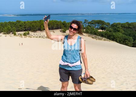 Eine italienische Touristin fotografiert sich auf der Dune du Pilat. Wiedereröffnung der Dune du Pilat und ihrer Touristen nach dem Brand. Frankreich, Le-Pyla-sur Mer, La Teste-De-Buch. 4. August 2022. Foto von Patricia Huchot-Boissier/ABACAPRESS.COM Stockfoto