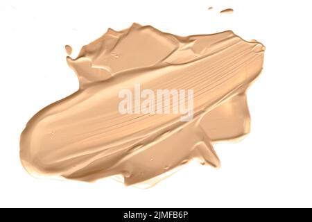 Beige kosmetische Textur isoliert auf weißem Hintergrund, verschmiert Make-up Emulsion Creme Abstrich oder Foundation Abstrich, zerkleinert CO Stockfoto