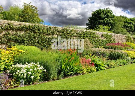 PITMEDDEN GARTEN ABERDEENSHIRE SCHOTTLAND IM SOMMER MEHRJÄHRIGE KRAUTIGE BLUME GRENZE ESPALIERED ÄPFEL UND BIRNEN Stockfoto