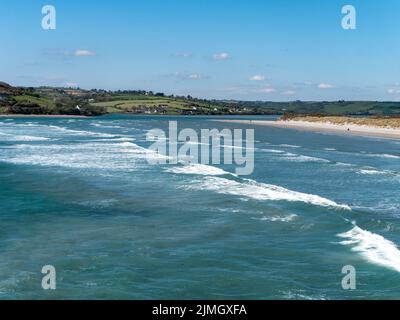 Malerische Bucht an einem sonnigen Tag. Wunderschöne Natur im Süden Irlands. Blaues Wasser des Atlantischen Ozeans unter klarem Himmel. Küstenlandschaft. Ozean wa Stockfoto