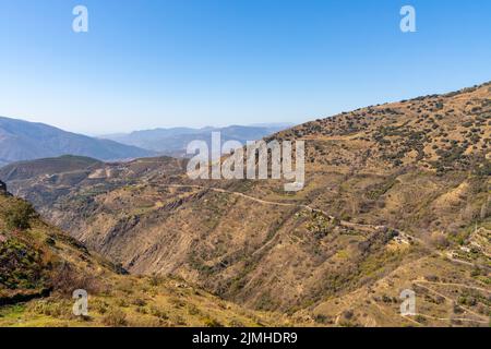 Eine Berglandschaft mit gewundenen Bergstraßen in den Ausläufern der Sierra Nevada in Südspanien Stockfoto