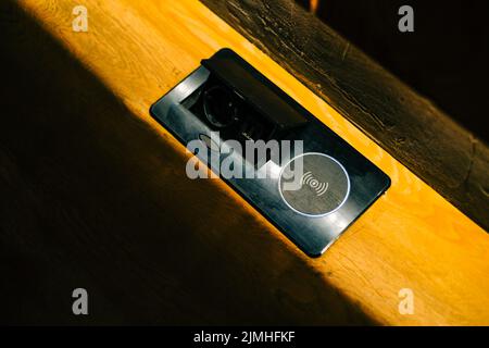 Drahtloses Ladegerät und usb-Anschlüsse im Restaurant. Stockfoto