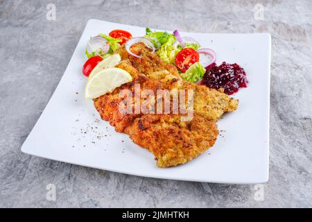 Traditionelles frittiertes Schnitzel mit grünem Salat Stockfoto