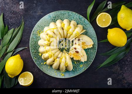 Traditioneller italienischer Budino di Ricotta Käse Puddingkuchen mit Rosinen und Zitronencreme serviert als Draufsicht auf einem Design-Teller mit Stockfoto