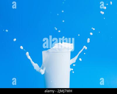 Milch aus dem Glas gießen Stockfoto