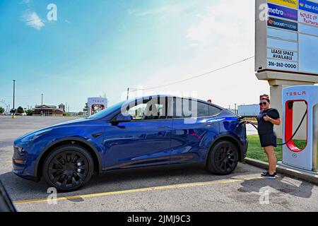 EMPORIA, KANSAS - 6. AUGUST 2022 Kacey aus Oklahoma City stopft an der Supercharger-Station in Emporia für das erste ihr brandneues in Austin, Texas, gebautes Tesla-Doppelmotor-Modell mit erweiterter Reichweite Y, das sie heute Morgen im Tesla-Showroom in Kansas City abgeliefert hat, Missouri. Kacey sagte, dass sie vier Monate auf ihr Auto gewartet habe, das sie liebt und das die zweite in ihrer Familie sein wird, da ihr Mann bereits eines hat. Stockfoto