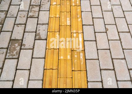 Taktile Pflasterung für blindes Handicap auf Fliesenbahn Stockfoto