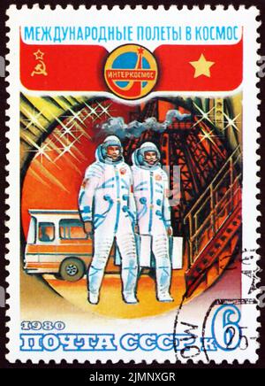 RUSSLAND - UM 1980: Eine in Russland gedruckte Briefmarke zeigt Kosmonauten, die in Sojus, Zentrum für Kosmonauten-Training, 20. Jahre, Interkosmos, um 19, einsteigen Stockfoto