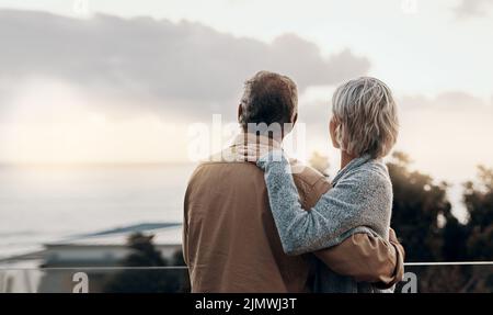 Wie vor vielen Jahren. Rückansicht eines unkenntlich reifen Paares, das sich umarmt und im Freien ein neues Jahr feiert. Stockfoto