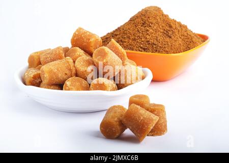 Bio-Gur oder Jaggery Pulver und Würfel, Jaggery wird als Zutat in süßen und herzhaften Gerichten in der Küche Indiens verwendet, Jaggery Pulver ist unre Stockfoto
