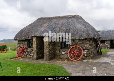 Nahaufnahme eines typischen Crofter Cottage mit dicken Steinmauern und einem reetgedeckten Schilfdach Stockfoto