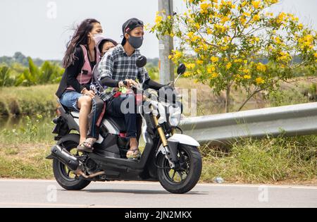 SAMUT PRAKAN, THAILAND, MAI 05 2022, Ein Elternteil fährt mit einem Sohn ein Motorrad. Stockfoto