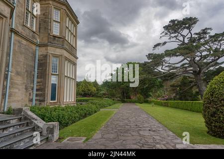 Killarney National Park, Co. Kerry, Irland: Ein Gehweg entlang der Seite des Muckross House, einem viktorianischen Herrenhaus mit 65 Zimmern, das 1843 erbaut wurde. Stockfoto