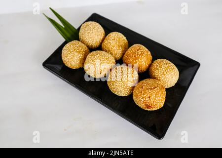 onde-onde oder Sesamball oder Jian Dui ist gebratenes chinesisches Gebäck, das aus klebrigem Reismehl hergestellt und mit Sesamsamen überzogen ist, die mit Bohnenpaste gefüllt sind. Stockfoto