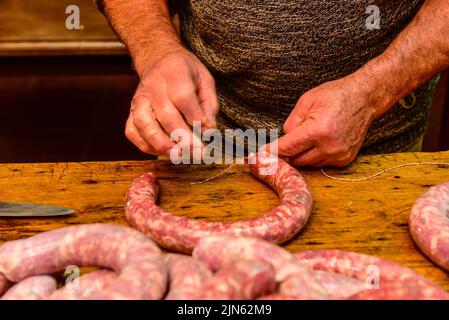 Hände arbeiten an der Herstellung von Würsten, traditionelle argentinische Schlachtung. Stockfoto