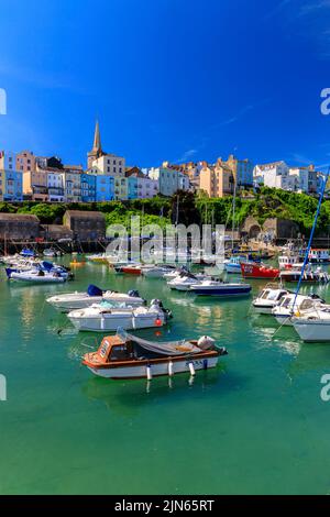 Der malerische geschützte Hafen wird von Reihen farbenfroher Häuser in Tenby, Pembrokeshire, Wales, Großbritannien, überblickt Stockfoto