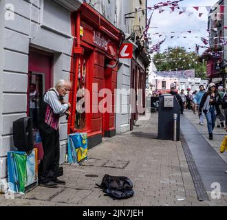 Ein Mann, der auf der High Street, Galway, Irland, eine Geige spielt. Stockfoto