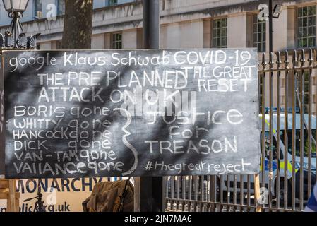 Covid 19 Verschwörungstheorie Protestschild in Whitehall, Westminster, London, Großbritannien. Botschaft von Klaus Schwab. Das tolle Reset Stockfoto