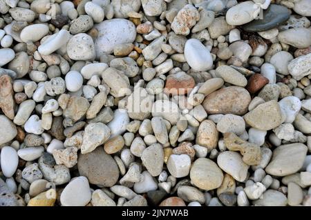 Mehrfarbige Kieselsteine und Strandsand Stockfoto