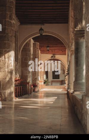 Schöner Bogen mit Laternen und Topfpflanzen in der Kirche Stockfoto