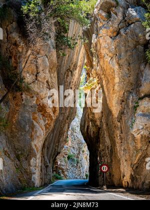 Ein schmaler Engpass in einer gefährlichen Kurve der Serra de Tramuntana Bergstraße MA-2141 führt durch das berühmte hohe Felsentor Sa Bretxa. Stockfoto