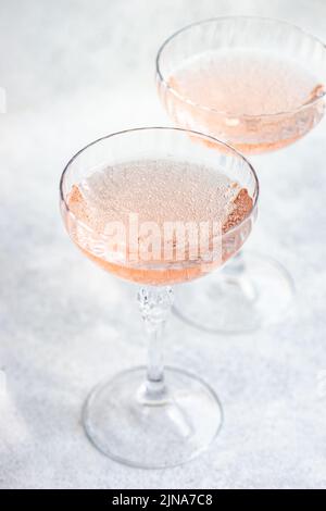 Nahaufnahme von zwei Gläsern rosa Champagner in Champagner-Coupé-Gläsern Stockfoto