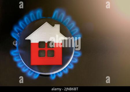 Gaskrise. Steigende Versorgungskosten in Polen. Energiekrise, Export-Import-Probleme in Polen. Das Konzept, der Gasbrenner und das Hausmodell sind eingefärbt Stockfoto