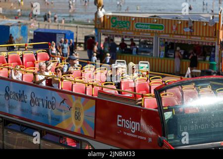 Open-Top-Bus, Oberdeck mit Passagieren, an einer Strandstraße an der englischen Küste in Essex, England. Roter Bus, Nahaufnahme, von oben, sonnig, hell Stockfoto