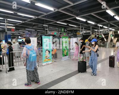 Shenzhen, China: Passagiere, die mit der Hochgeschwindigkeitsbahn nach Shenzhen einreisen, müssen über einen grünen Code für die 48-Stunden-Nukleinsäureerkennung verfügen. A1 das Exit-Personal überprüft den Stockfoto