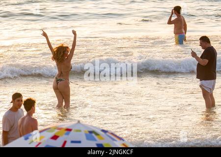 Tel Aviv, Israel. 10. August 2022. Eine Frau posiert während des Sonnenuntergangs in Tel Aviv für ein Bild. Tel Aviv, das sich an der Mittelmeerküste befindet, ist Israels kulturelles Zentrum und ein wichtiges Reiseziel, das Touristen aus der ganzen Welt anzieht. (Bild: © Ronen Tivony/SOPA Images via ZUMA Press Wire) Stockfoto