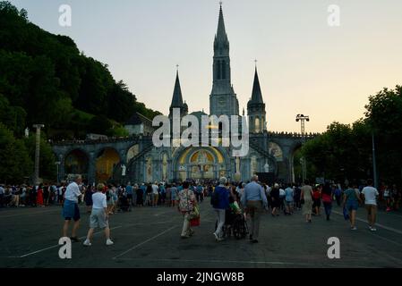 Menschen versammelten sich @ Sanctuaires Notre-Dame de Lourdes Eine katholische Pilgerfahrt. Nächtliche Kerzenschein-Messe-Wallfahrtskirche unserer Lieben Frau von Lourdes. Lourdes-Prozession. Stockfoto