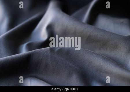 Schwarzer gewellter texturierter Hintergrund aus Stoff, Hintergrund mit Stofftextur Stockfoto