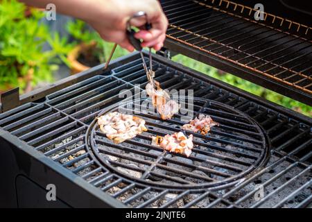 Speck Kochen auf dem heißen Grill, Vorbereitung von ungesunden Lebensmitteln. Stockfoto
