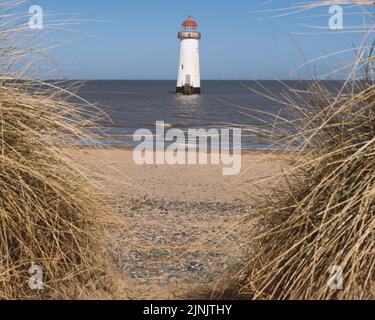 Der Punkt des Ayr Lighthouse in Wales, der vom trockenen Grasgebiet aus sichtbar ist Stockfoto