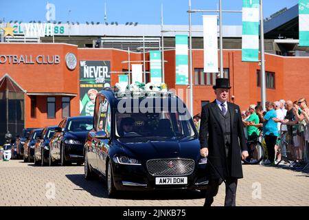 Der Leichenwagen, der den Sarg des ehemaligen keltischen Spielers John Hughes trägt, kommt im Celtic Park in Glasgow an. Bilddatum: Freitag, 12. August 2022. Stockfoto