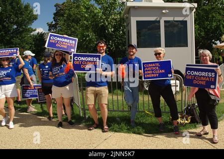 Washington DC, USA. 12. August 2022, Klimaaktivisten halten Schilder vor dem US-Kapitol hoch, als das Repräsentantenhaus über das Inflationsreduktionsgesetz stimmte. Quelle: Philip Yabut/Alamy Live News Stockfoto